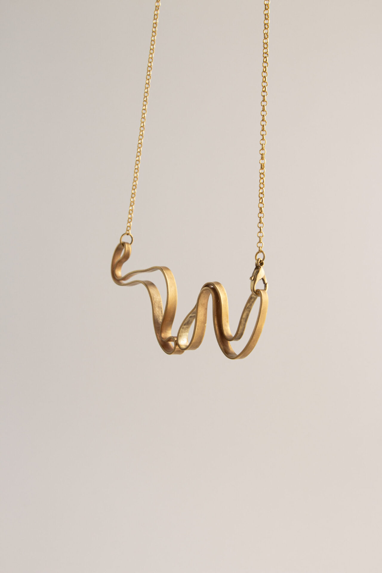 Abstract shaped ornament 18K gold-plated necklace.
