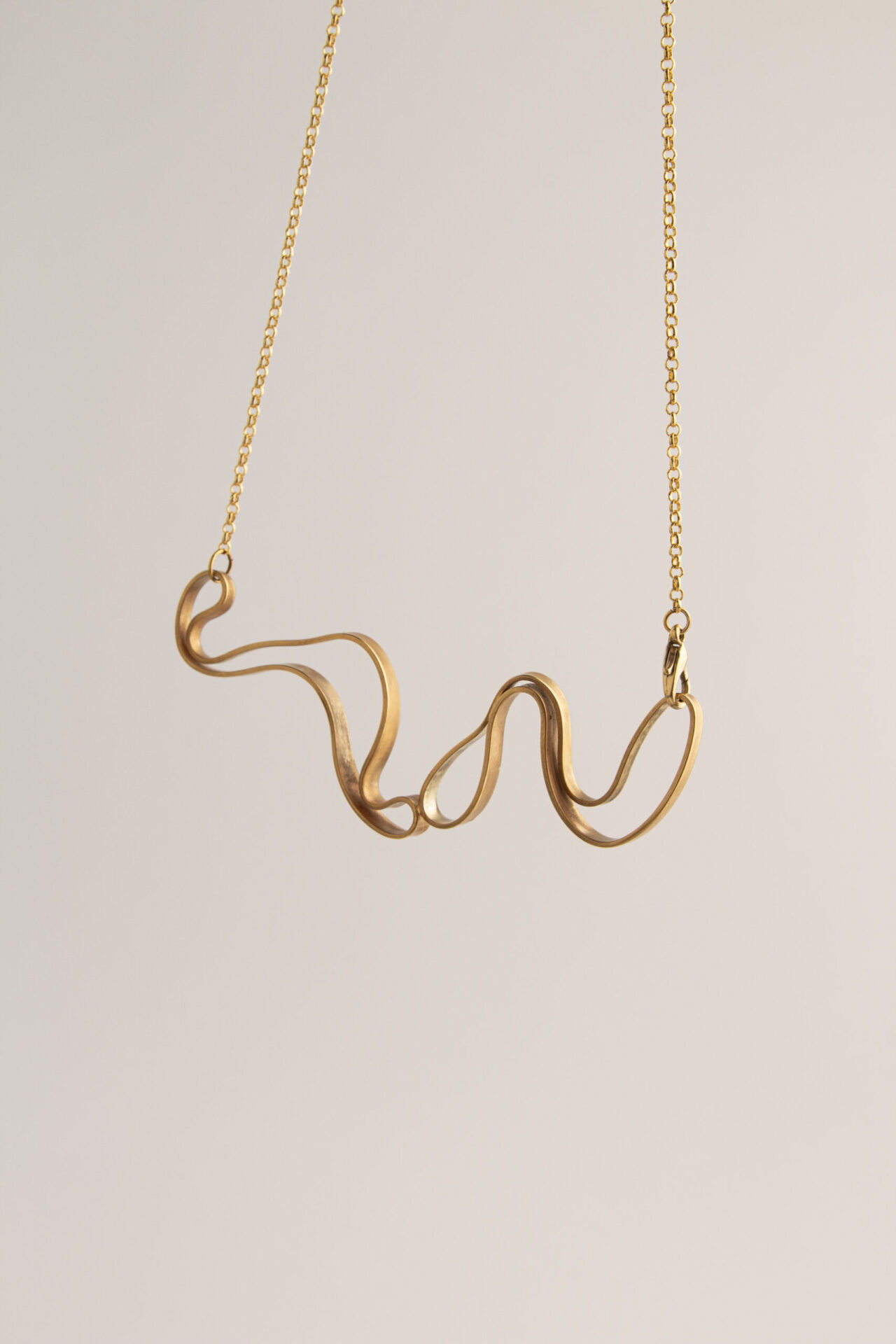 Abstract shaped ornament 18K gold-plated necklace.
